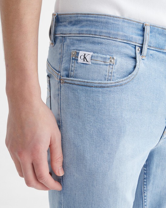 Infinite Flex Distressed Body Taper Jeans